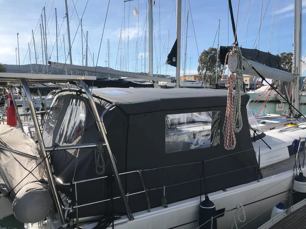 A dark cockpit enclosure with clear windows closing in the aft deck of a yacht