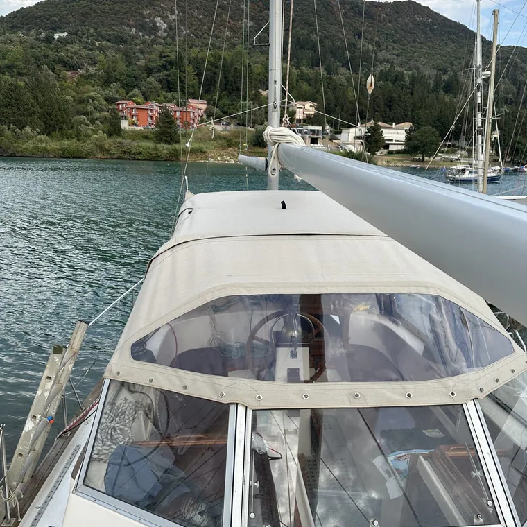 Bimini and sprayhood on a yacht moored in a green bay