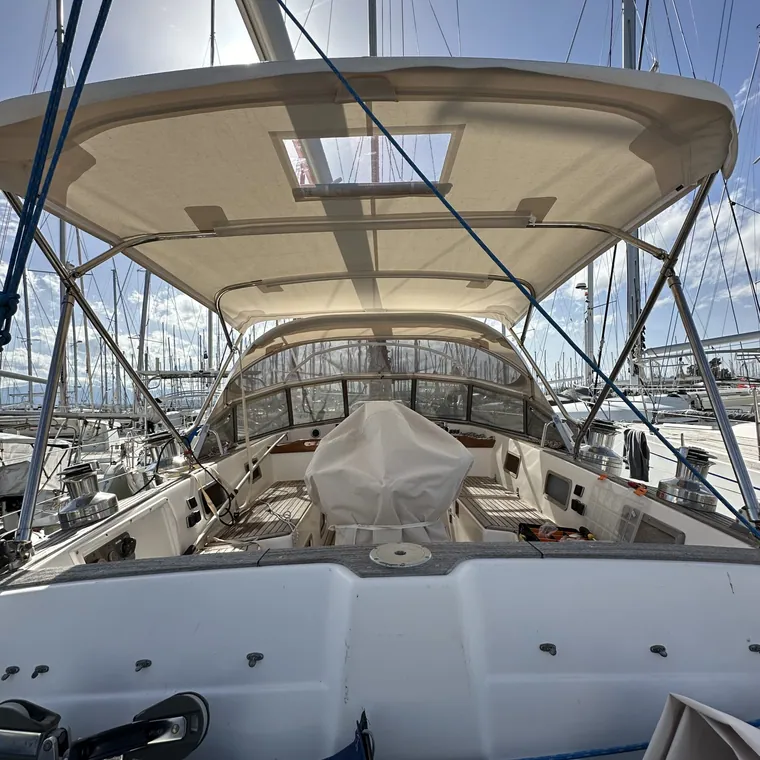 Cream bimini with a clear inspection window over a yacht cockpit