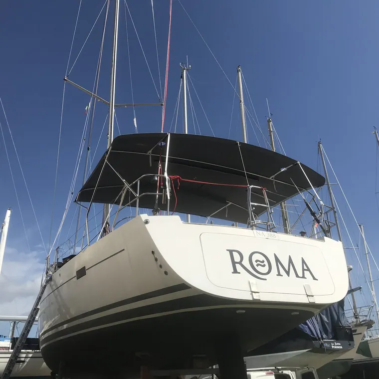 Motor yacht in a marina with the cockpit shaded by a fitted bimini