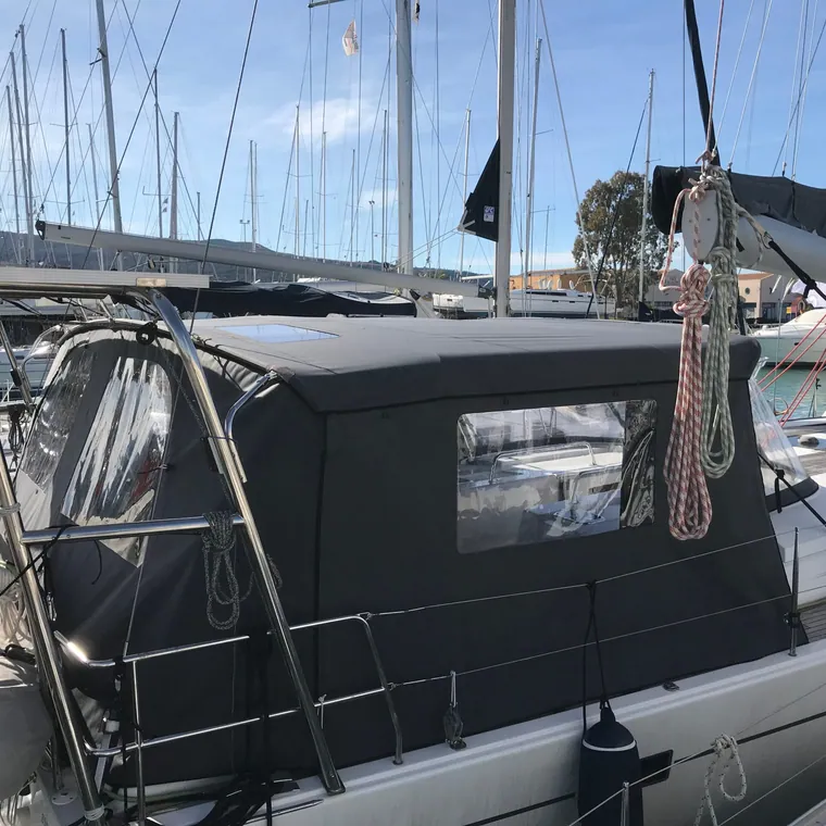 Dark cockpit enclosure with clear windows closing in the aft deck of a yacht