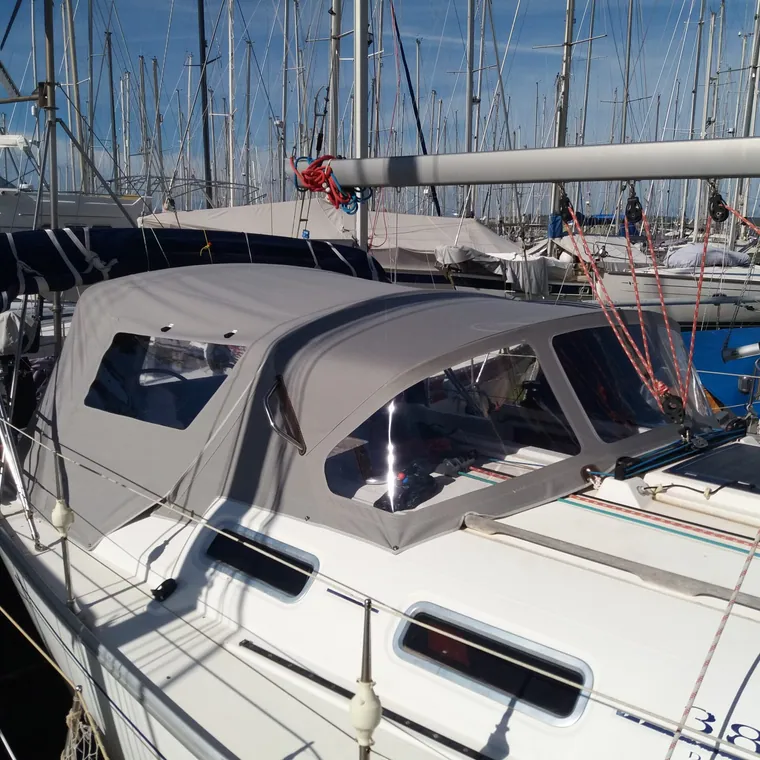 Grey enclosure with clear panels around the cockpit of a sailing yacht