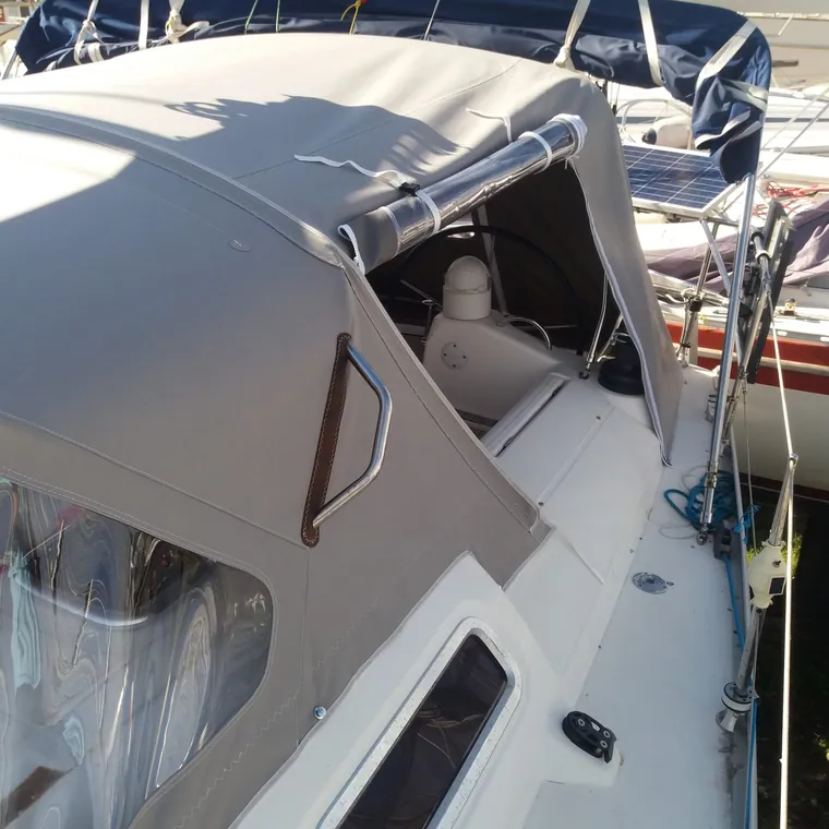 Cream enclosure fitted around the cockpit of a motor yacht