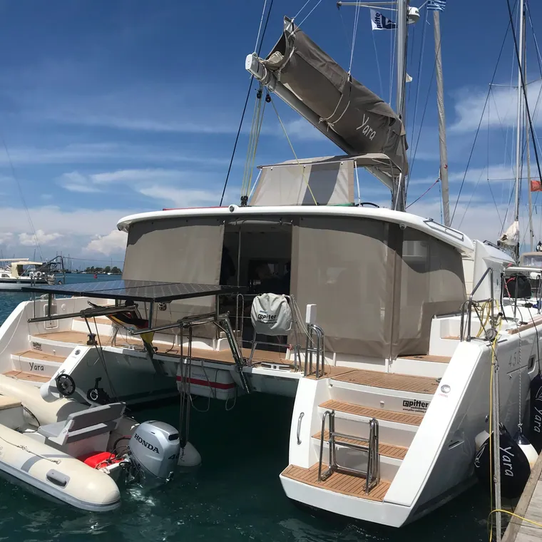 Catamaran with the cockpit closed in behind clear panels