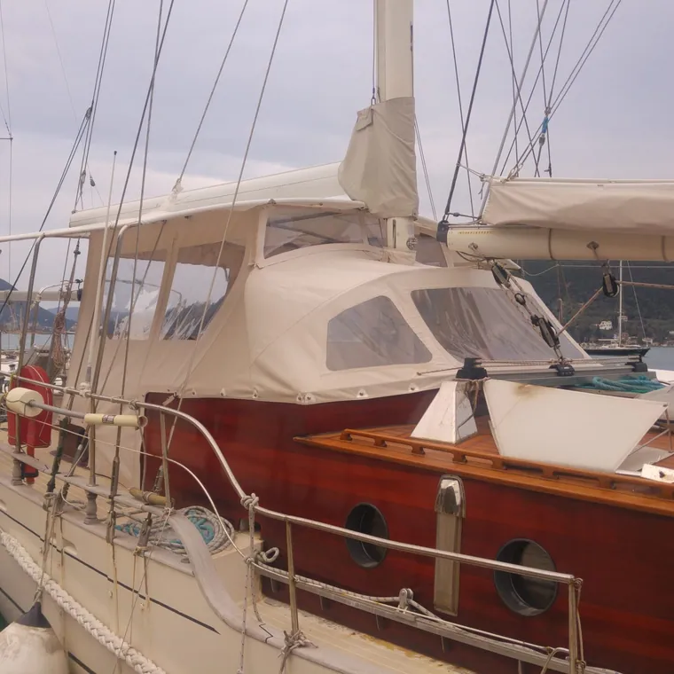 Cream enclosure over the cockpit of a classic wooden yacht