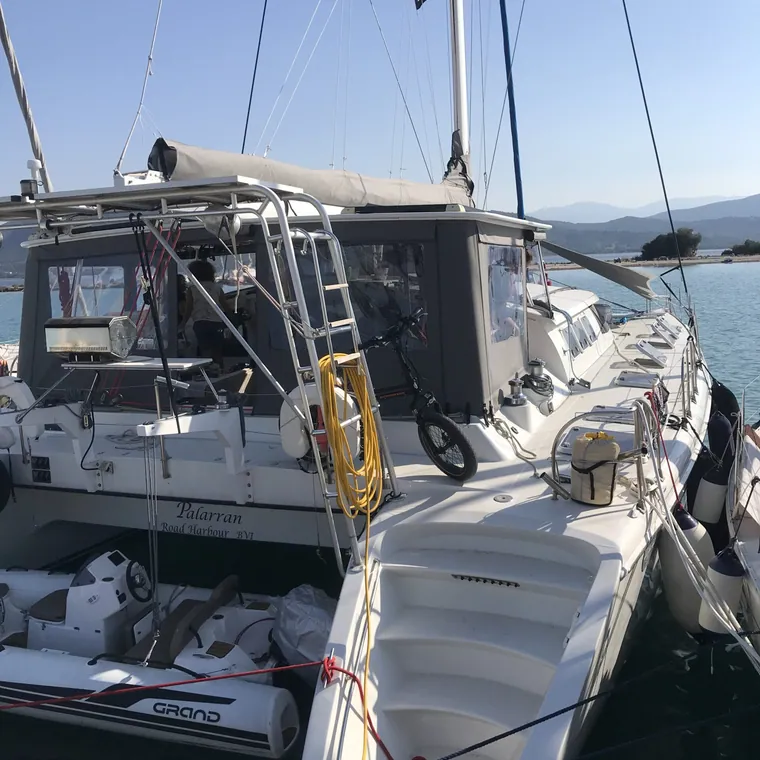Enclosure panels zipped in along the side deck of a catamaran