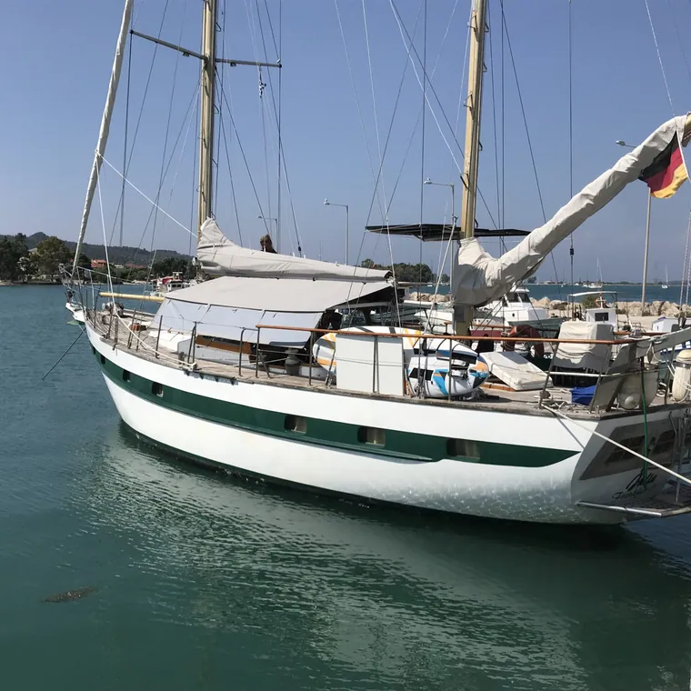 Classic ketch alongside with the mainsail stowed in its cover