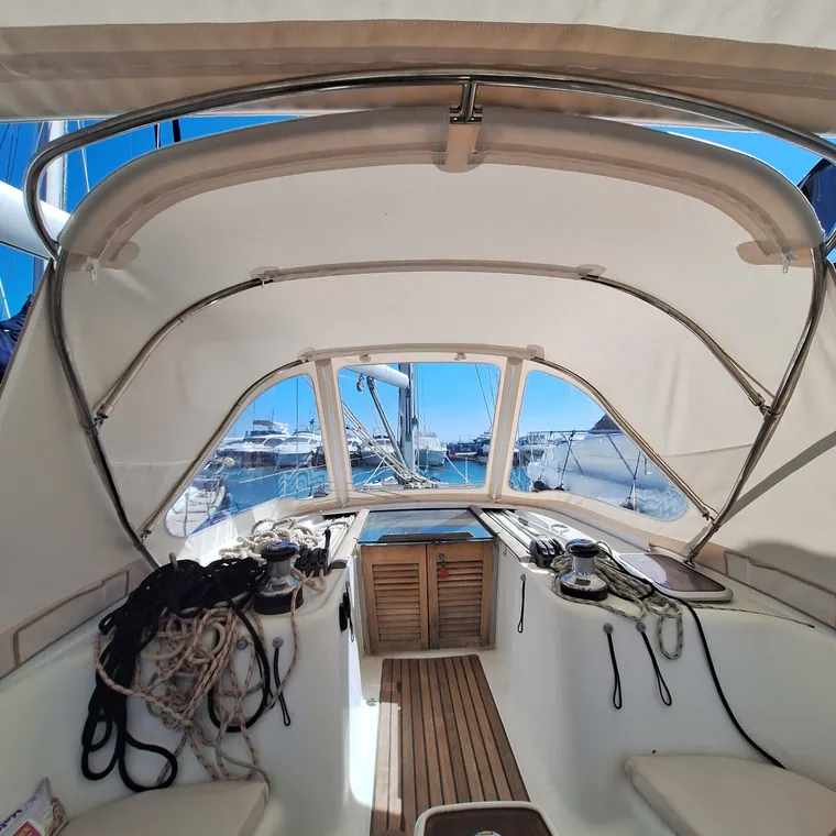 Tan sprayhood seen from the cockpit looking forward down the teak deck