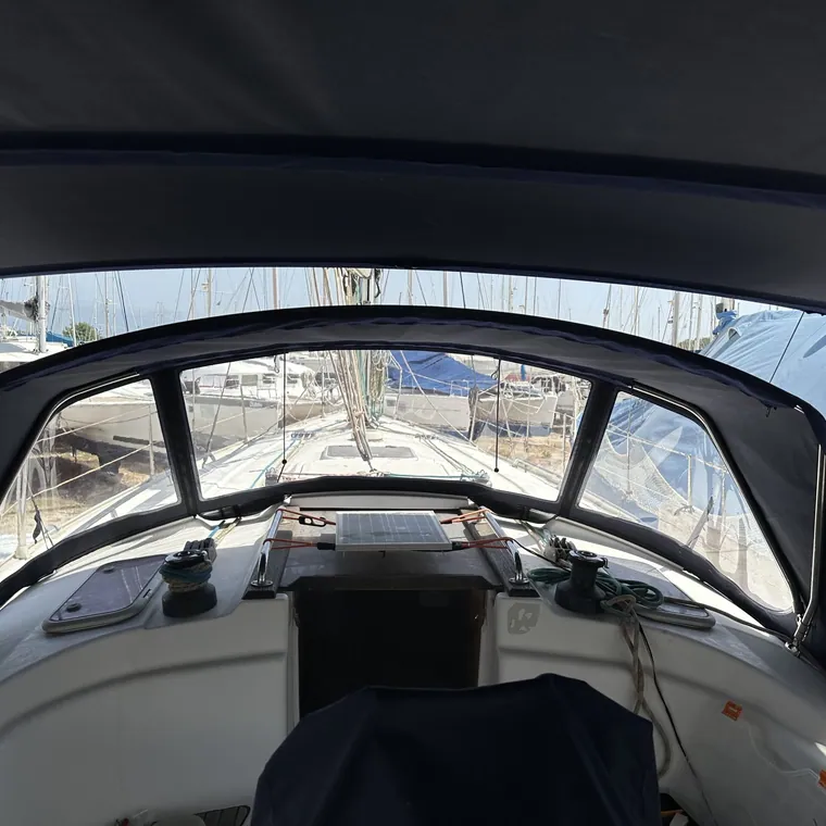 Sprayhood seen from the helm, the marina beyond the windows