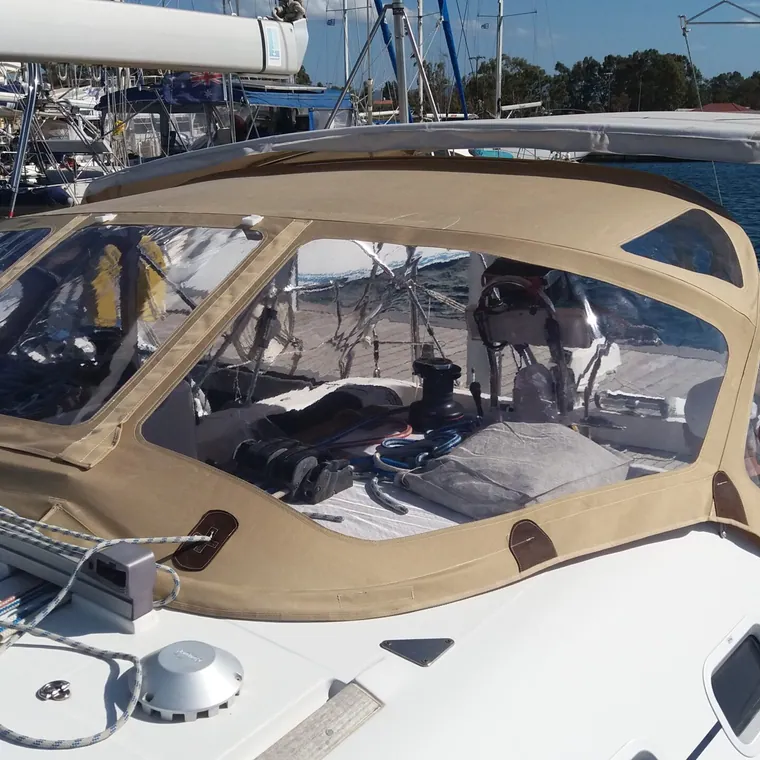 Tan sprayhood and cockpit canvas on a yacht alongside in a marina