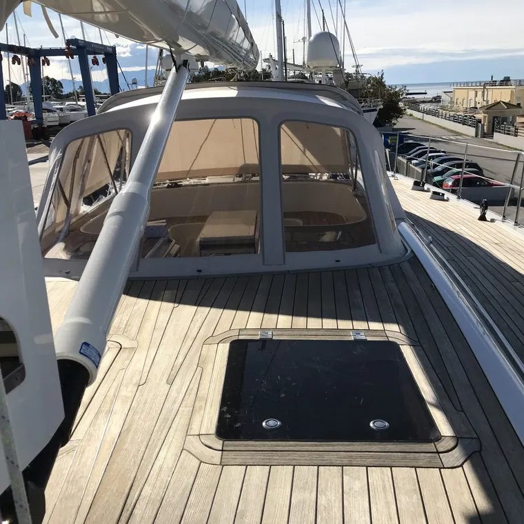 Sprayhood and side panels on the wide teak deck of a large yacht
