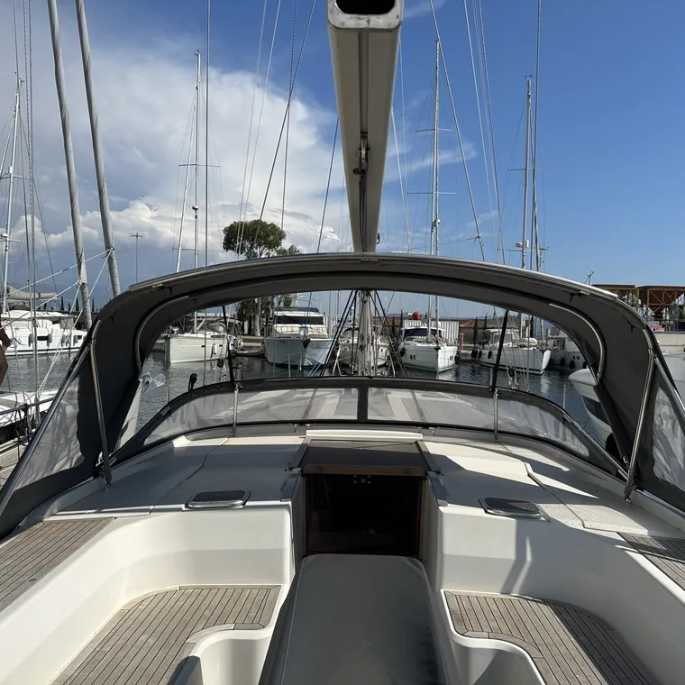 Sprayhood folded down flat along the coachroof of a yacht
