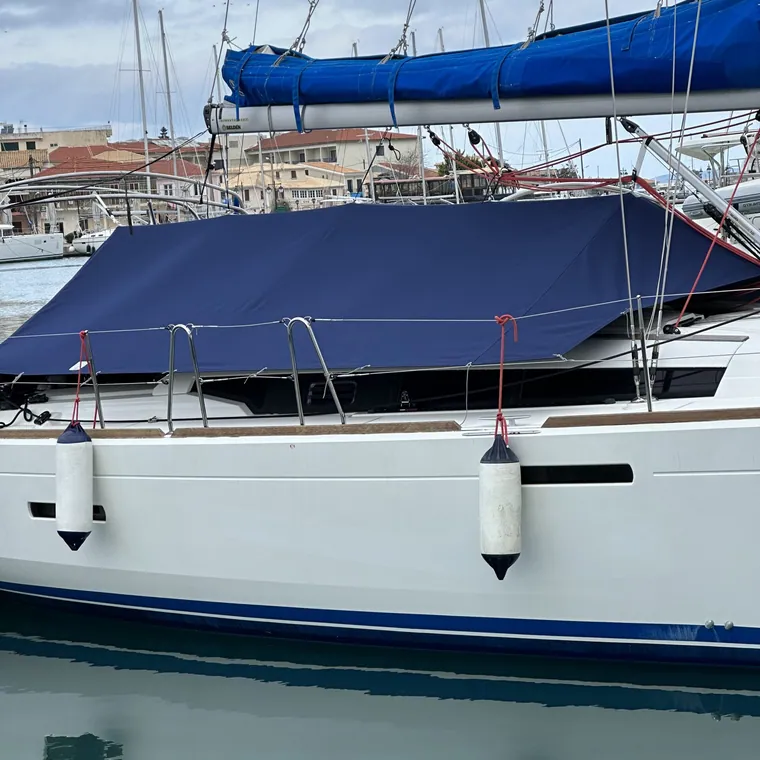 Navy cover over the foredeck and companionway of a yacht alongside