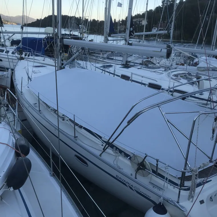Sailing yacht alongside under a cover cut around the mast and rigging