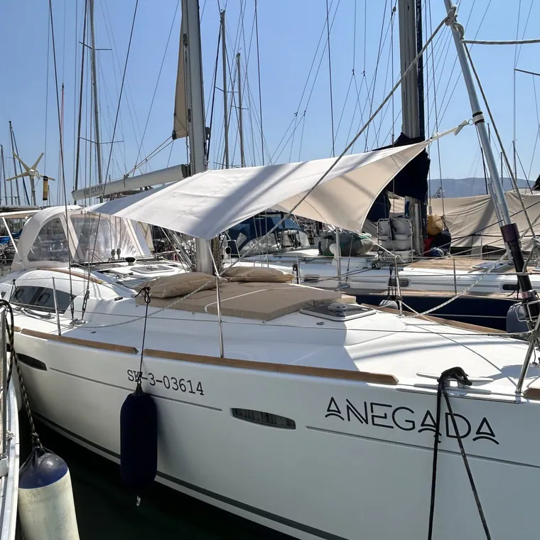 Sailing yacht alongside with a shade sail set over the cockpit